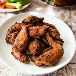 A plate full of smoked chicken wings