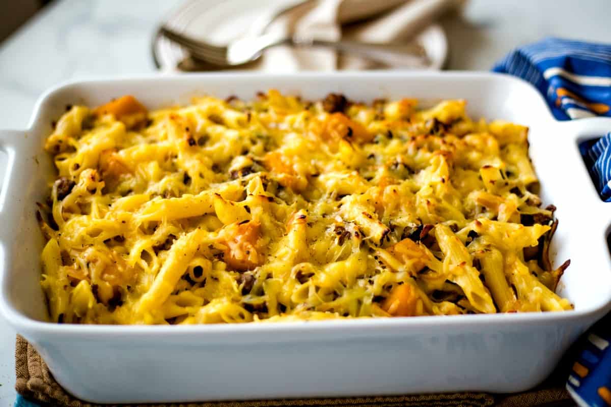 Butternut Squash Italian Sausage Pasta Bake in white casserole dish