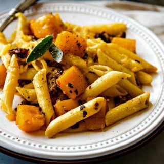 Butternut Squash Italian Sausage Pasta Bake on a white plate with fork