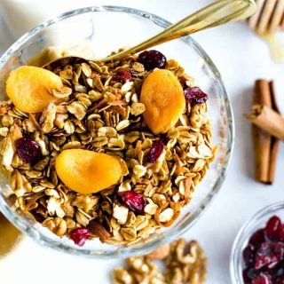 Nutty Granola in a glass bowl with dried apricots and cranberries