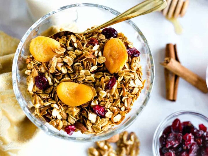 Nutty Granola in a glass bowl with dried apricots and cranberries