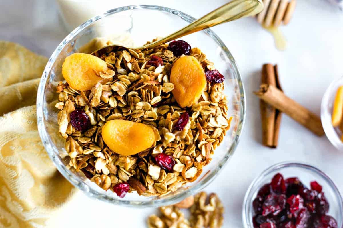 Nutty Granola in a glass bowl with dried apricots and cranberries