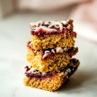 raspberry coconut oatmeal bars stacked on a table