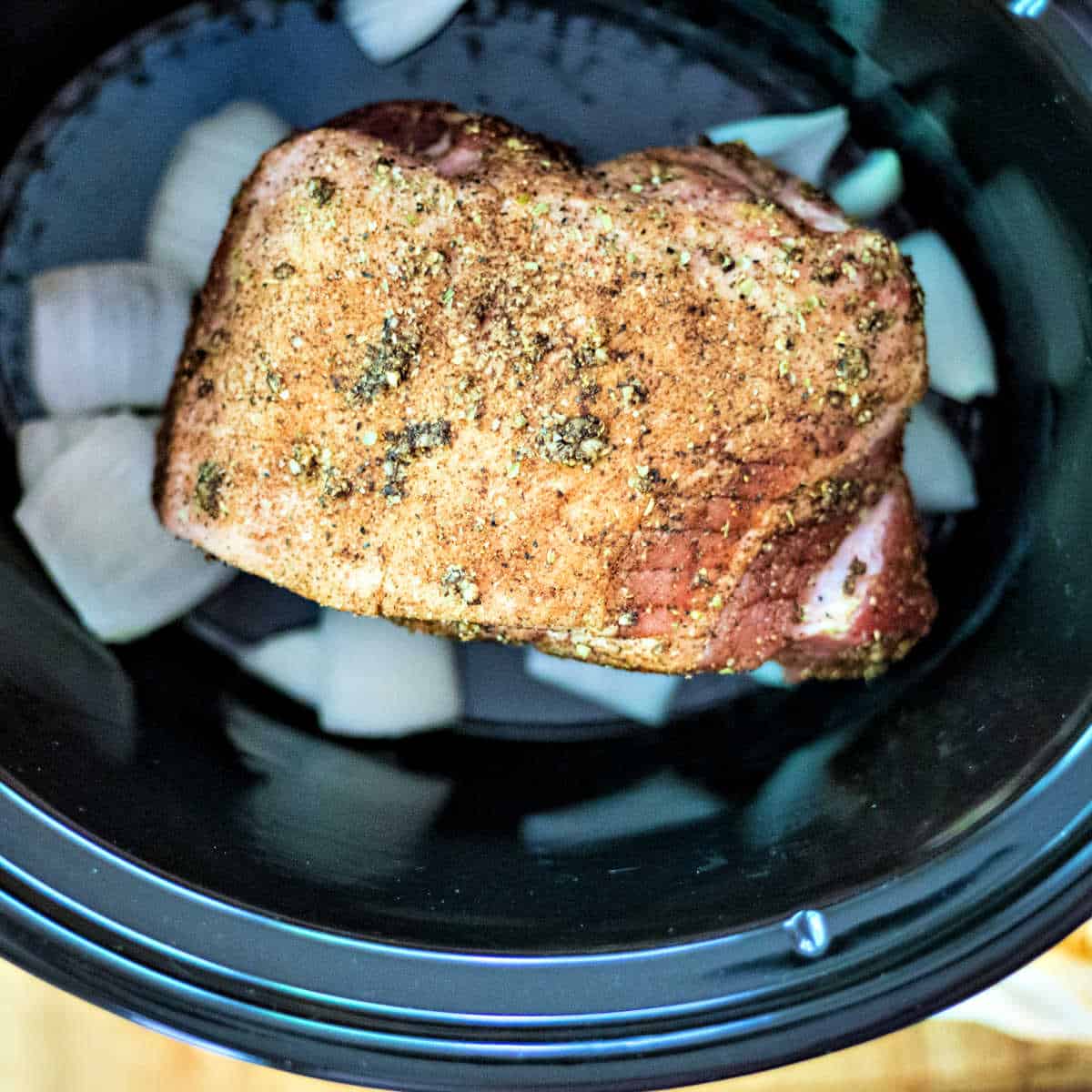 pork carnitas in process in a slow cooker