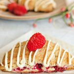 raspberry scones on a Valentine heart plate with roses o a table