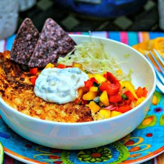 A bowl of food on a plate, with Fish Tacos
