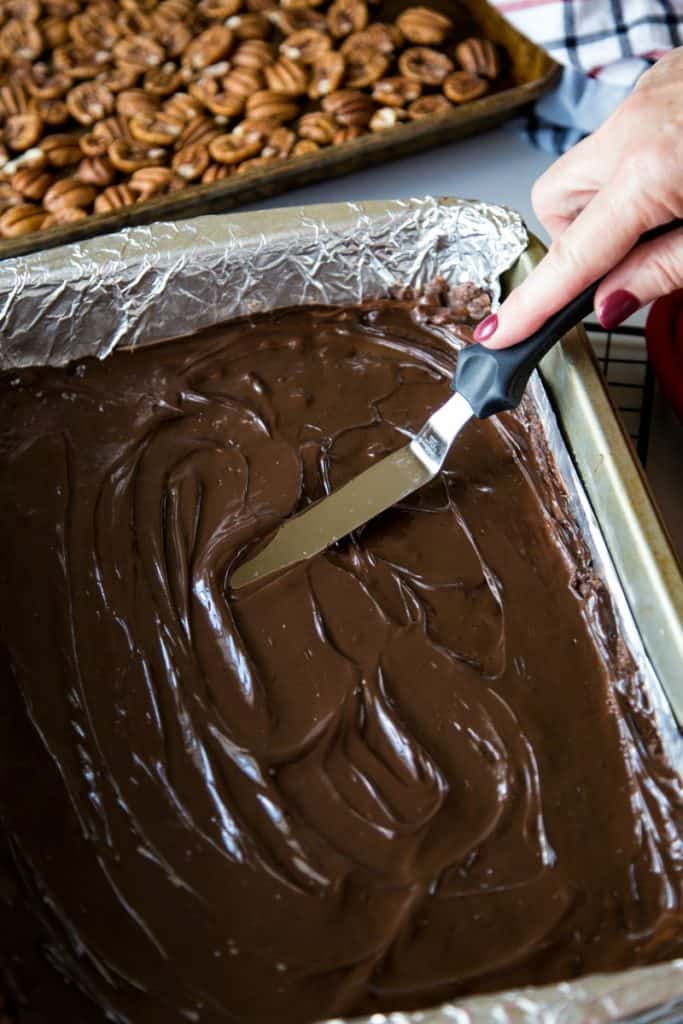 Spreading chocolate in a baking dish with a spatula