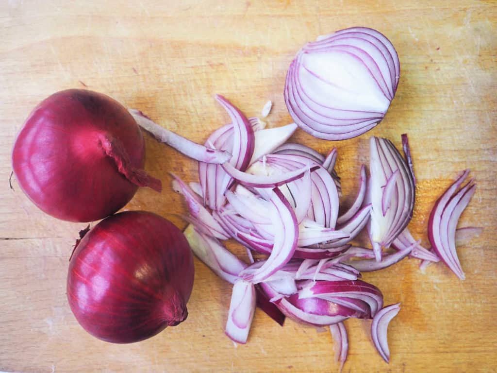slicing shallots on a cutting board