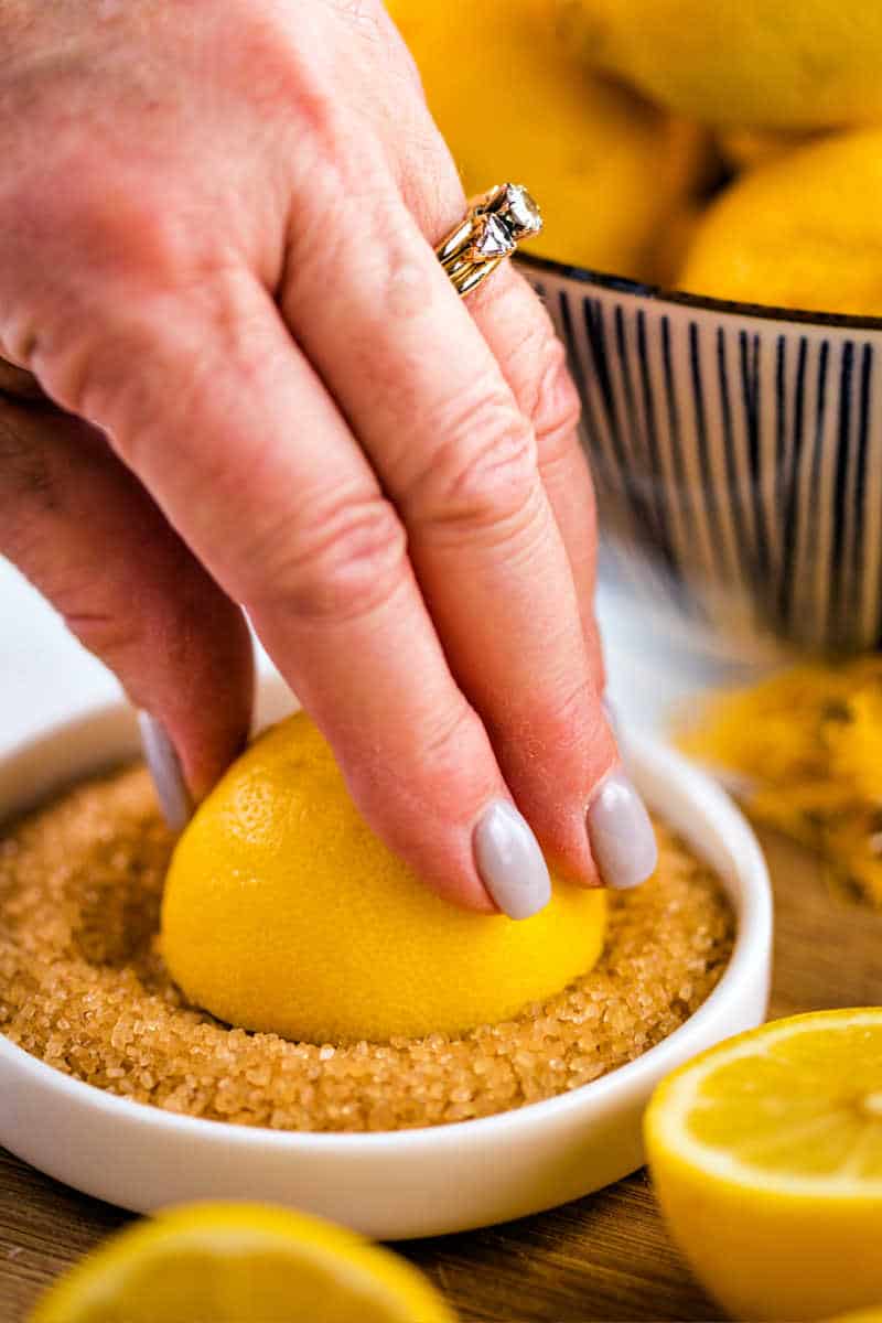 dredging a lemon half in turbinado sugar