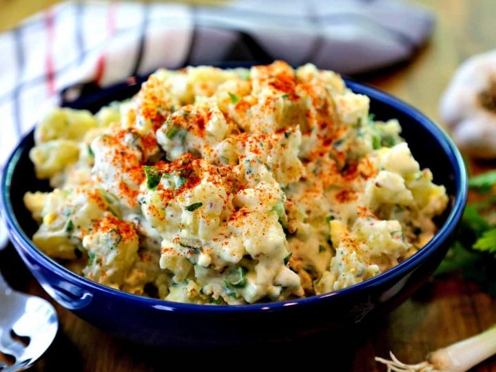 A bowl of fresh herb potato salad on a table
