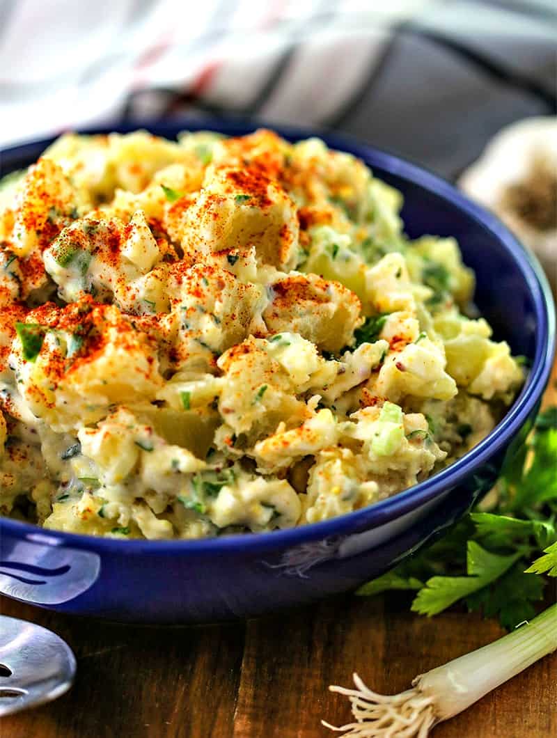 A dish is filled with fresh herb potato salad
