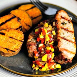 A plate of food, with Sweet potato and country style pork ribs