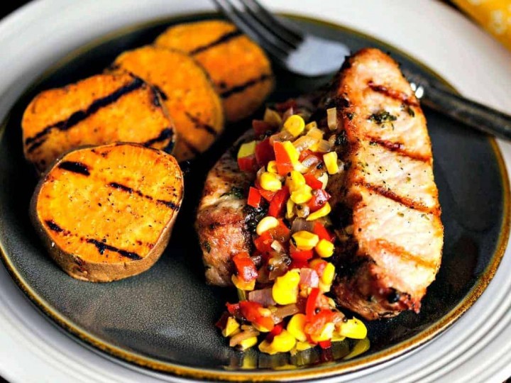 A plate of food, with Sweet potato and country style pork ribs