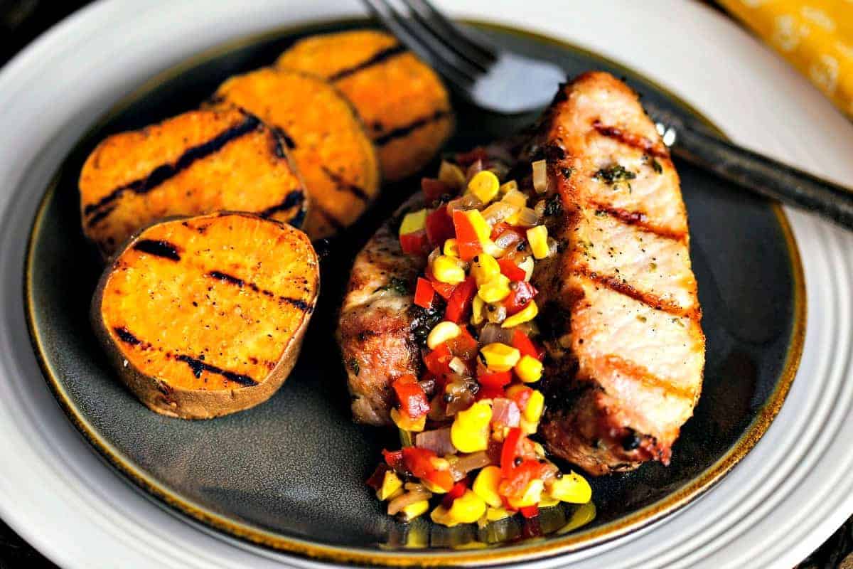 A plate of food, with Sweet potato and country style pork ribs