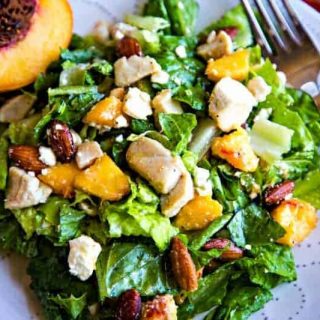 A plate of salad and a fork, with Peaches and Chicken