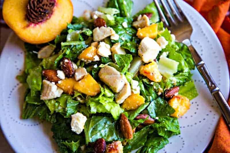 A plate of salad and a fork, with Peaches and Chicken