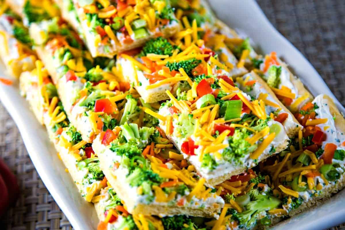 cool veggie pizza squares on a white serving tray