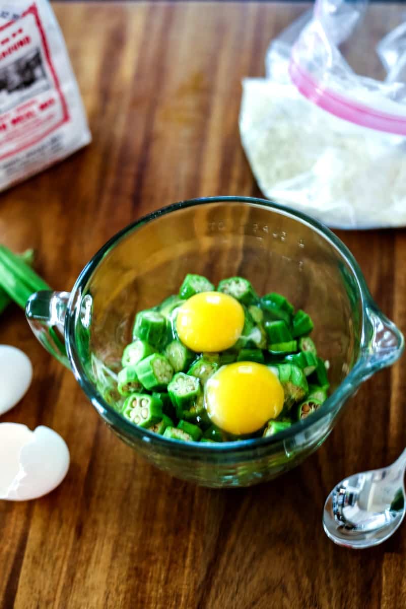 sliced okra with eggs in a mixing bowl