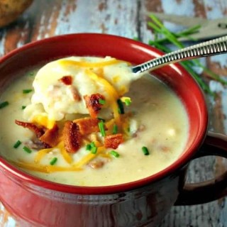 A bowl of soup, with baked potato soup