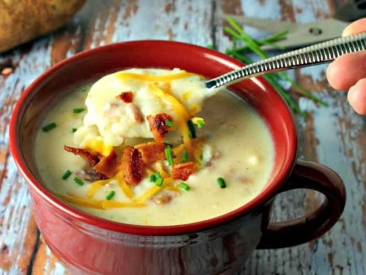 A bowl of soup, with baked potato soup