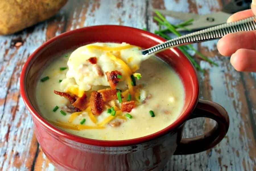 A bowl of soup, with baked potato soup