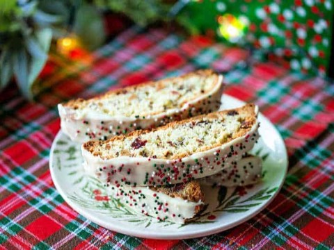 a plate of biscotti on a red tartan tablecloth