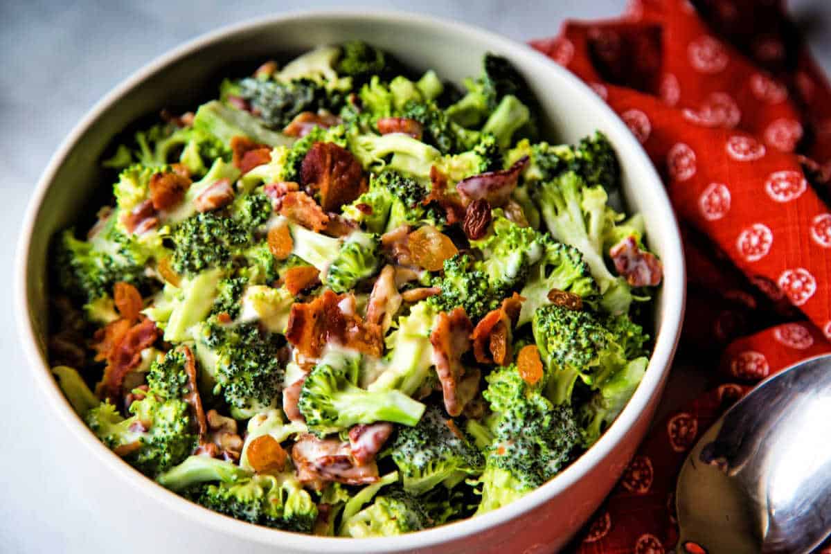 broccoli and bacon salad in a white bowl