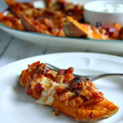 A plate of food with a piece of loaded sweet potato skins