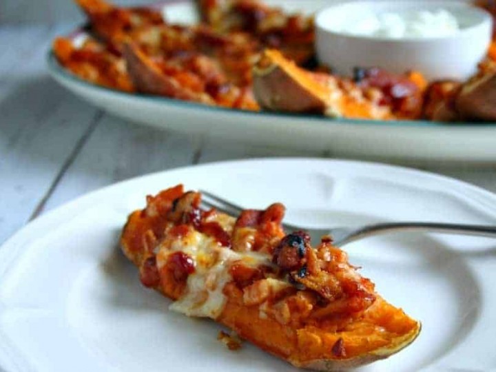 A plate of food with a piece of loaded sweet potato skins