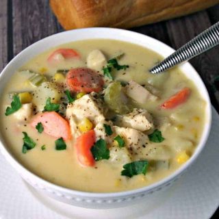 A bowl of Cheesy Chicken Vegetable Chowder on a plate