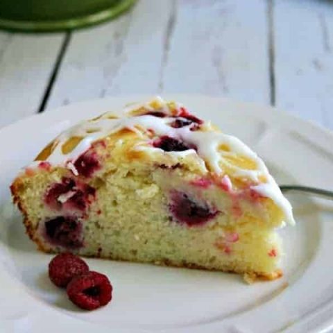 A piece of cake on a plate, with Raspberry Ricotta Cake