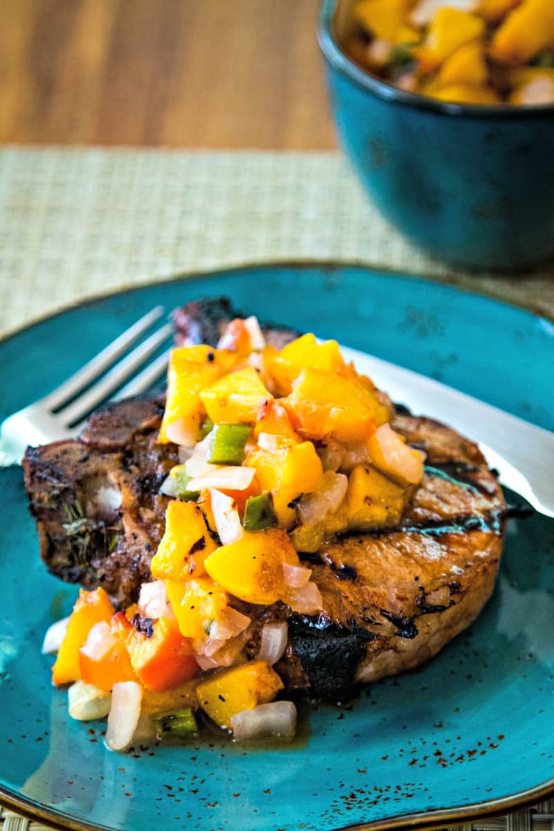 pork chop with peach salsa on dinner plate