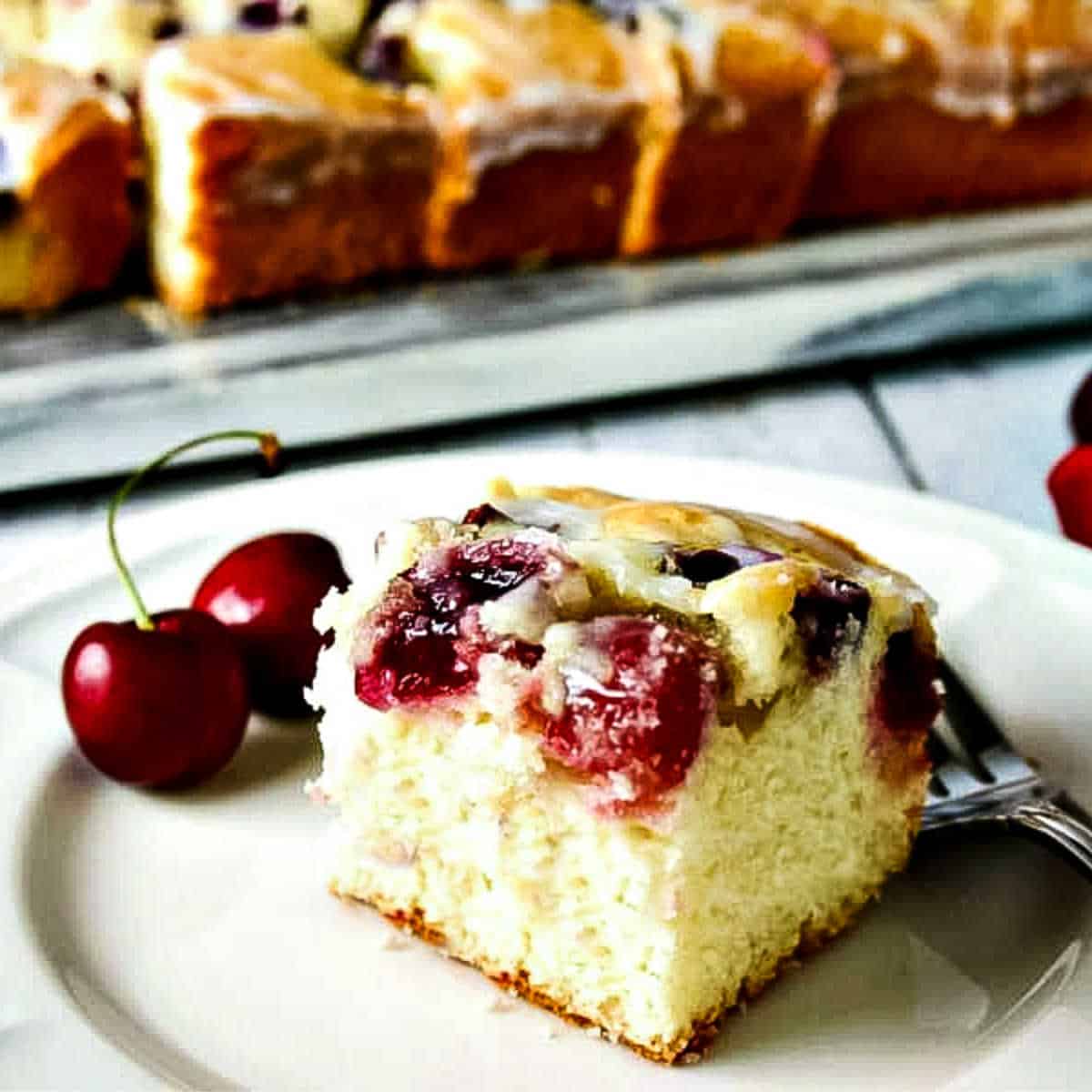 a piece of cherry cake on a white plate