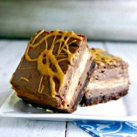 A slice of chocolate peanut butter cheesecake squares on a plate