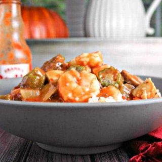 A bowl of food on a table, with Chicken, Sausage, and Shrimp Gumbo