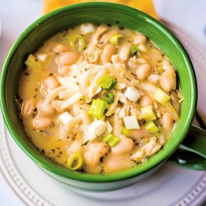 white chicken chili in a green soup bowl