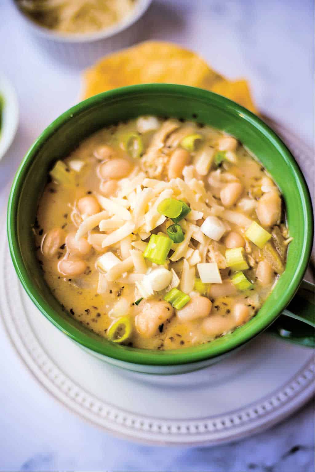 white chicken chili in a green soup bowl