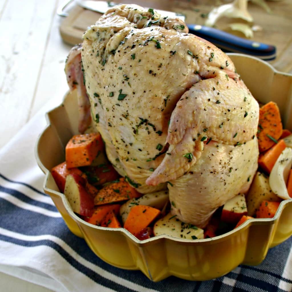 A Bundt pan filled with chinks of vegetables and a chicken ready for the oven, with Rotisserie Chicken and roasted vegetables