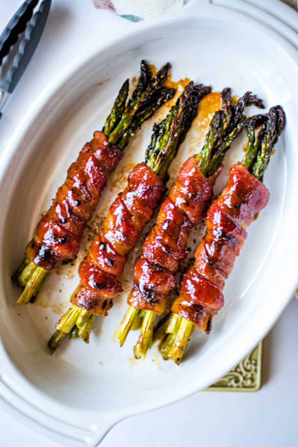 Bacon Wrapped Asparagus in a white baking dish