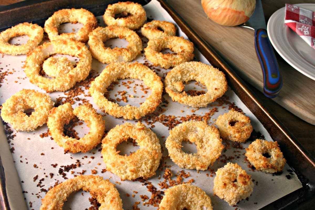 A close up of a tray of dCrispy Oven Baked Onion Rings on a table