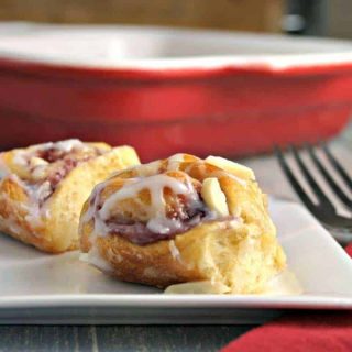 A plate of food on a table, with raspberry almond sweet rolls