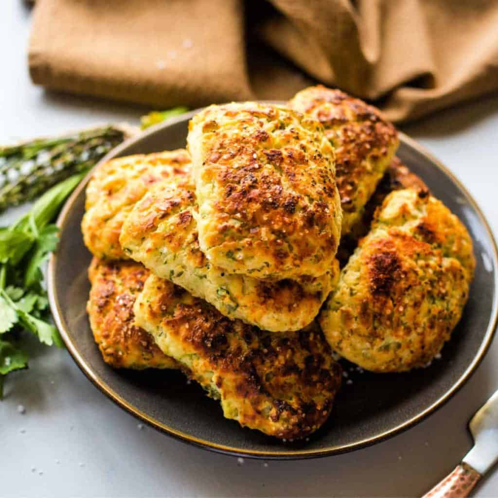 a plate of savory ricotta scones on a table garnished with fresh herbs