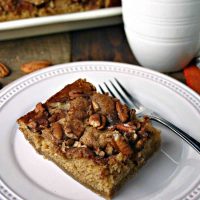 A slice of Brown Sugar Pecan Coffee Cake on a plate on a table