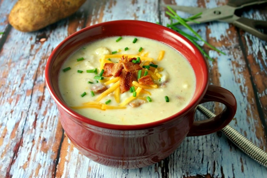 A bowl of soup on a table, with Baked Potato Soup
