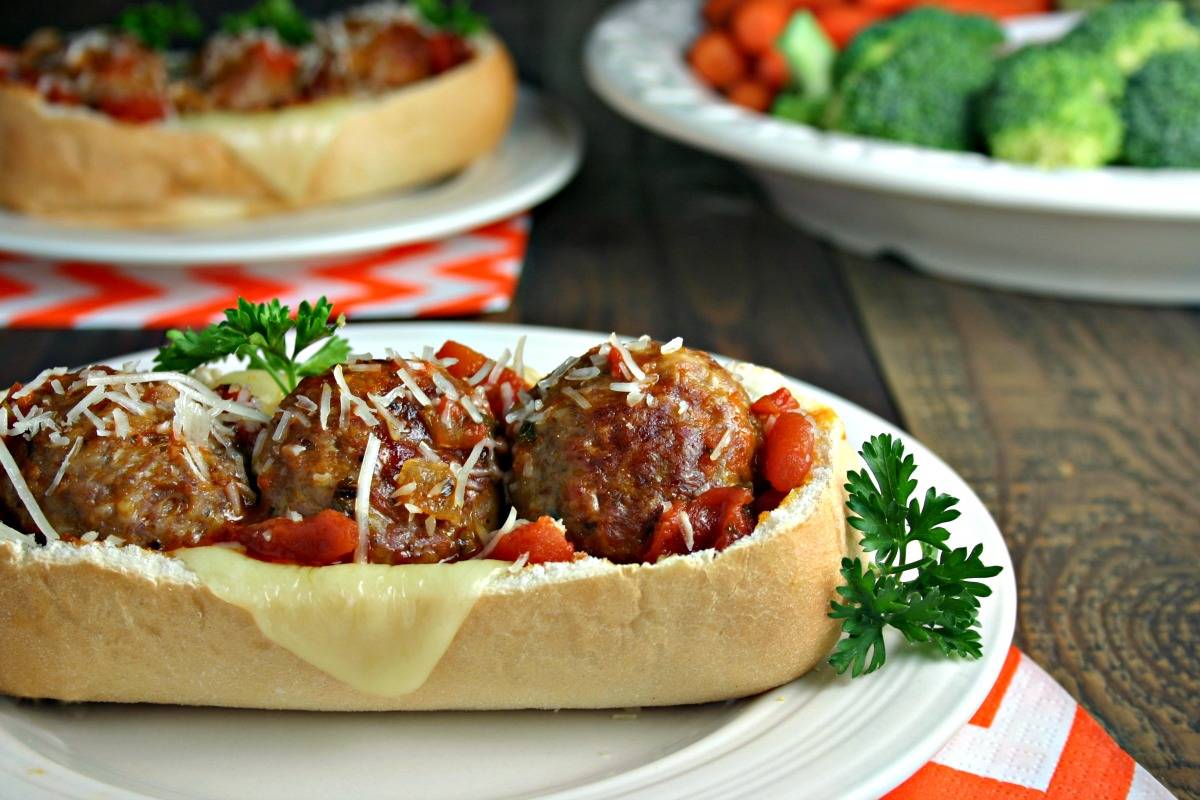 A close up of a plate of food on a table, with Italian Meatball Subs