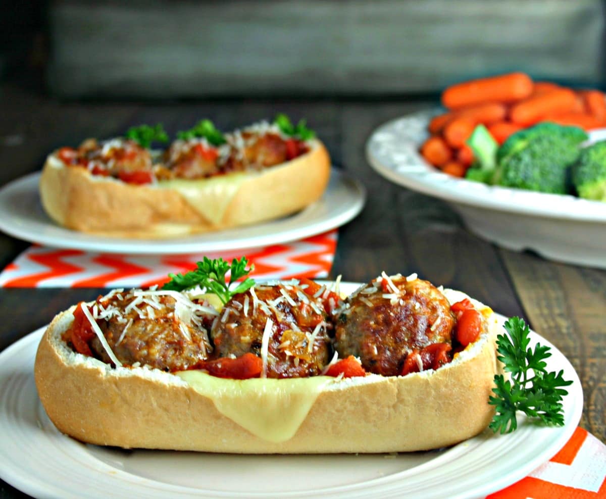 A close up of a plate of food on a table, with Italian Meatball Subs