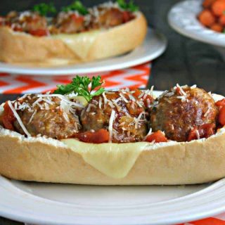 A close up of a plate of food on a table, with Italian Meatball Subs