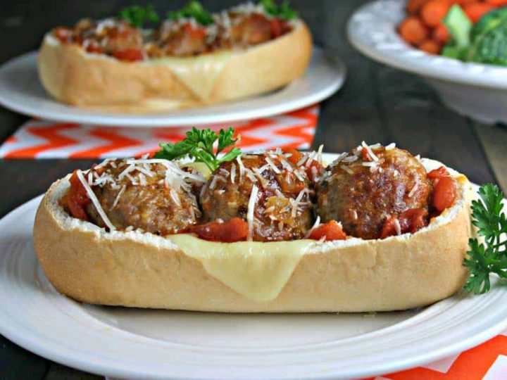 A close up of a plate of food on a table, with Italian Meatball Subs