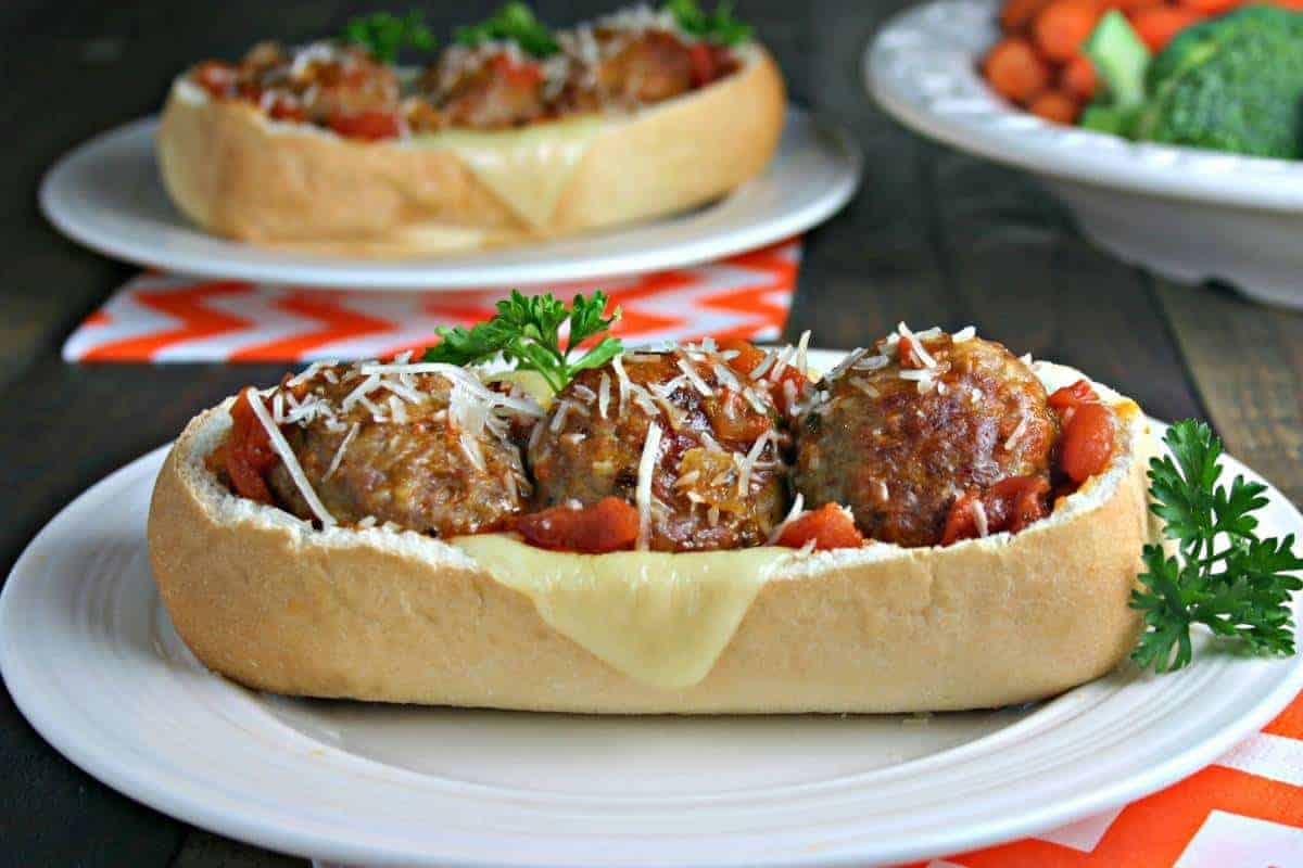 A close up of a plate of food on a table, with Italian Meatball Subs