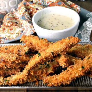 A plate of food on a table, with Portabello Fries with Belchamel Mustard Dipping Sauce